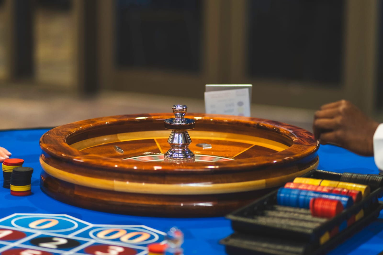 A roulette wheel at a casino-night fundraiser, chips and layout in soft focus.