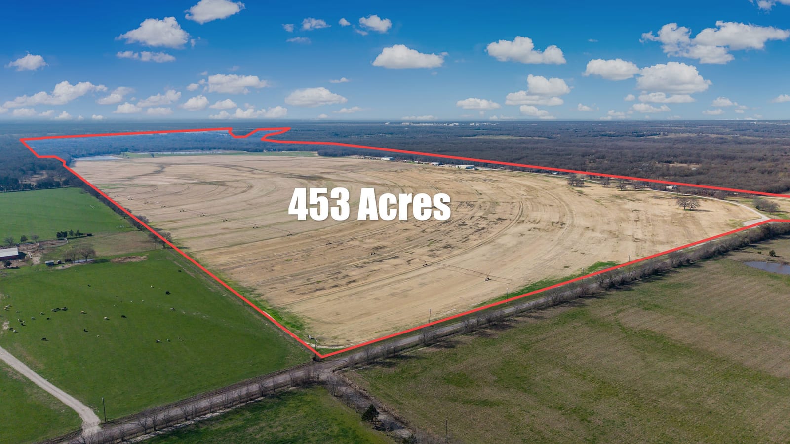 An aerial of open farmland with the parcel boundary drawn onto the frame and its acreage labelled.