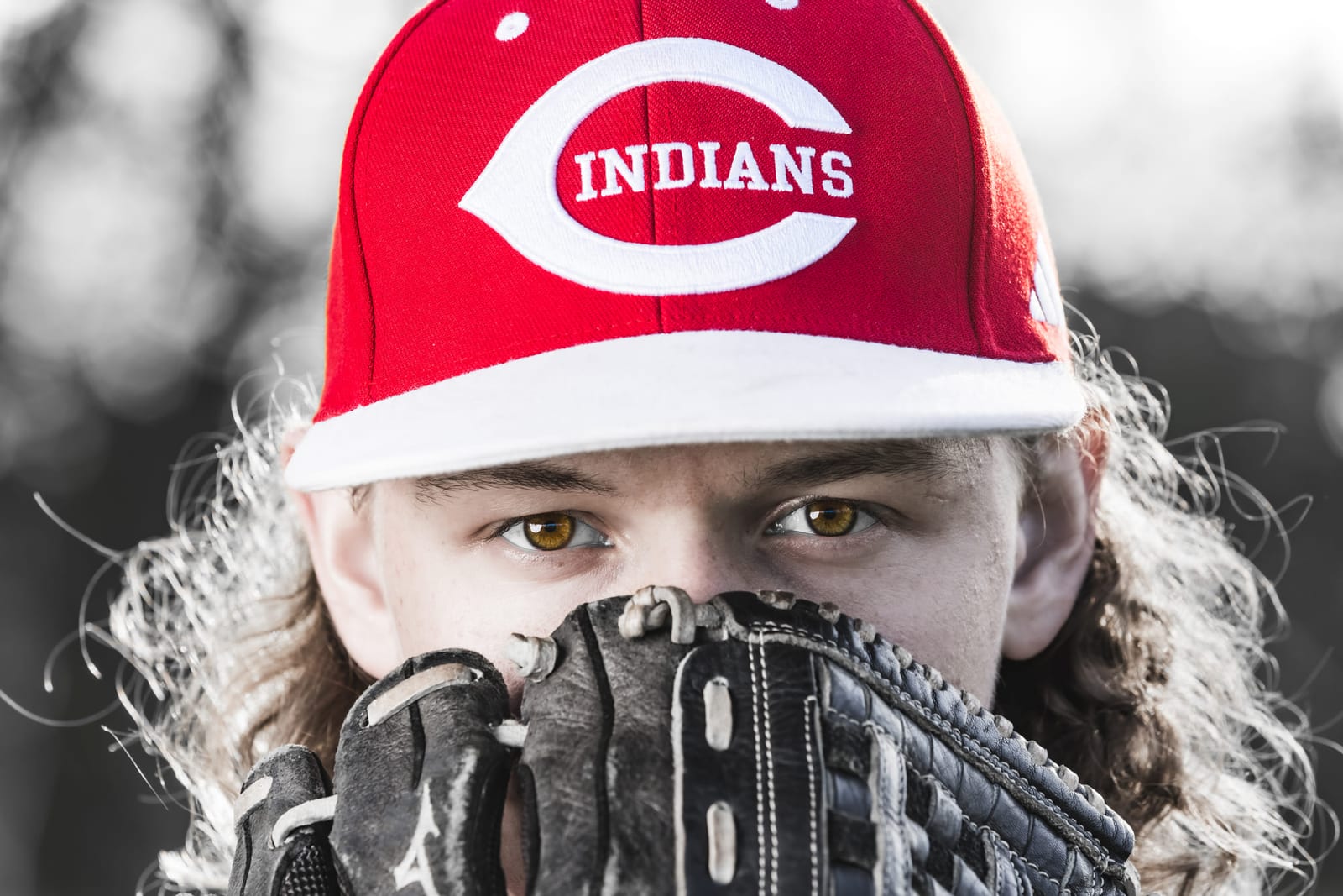 A black-and-white frame of a player’s eyes above a raised catcher’s mitt.