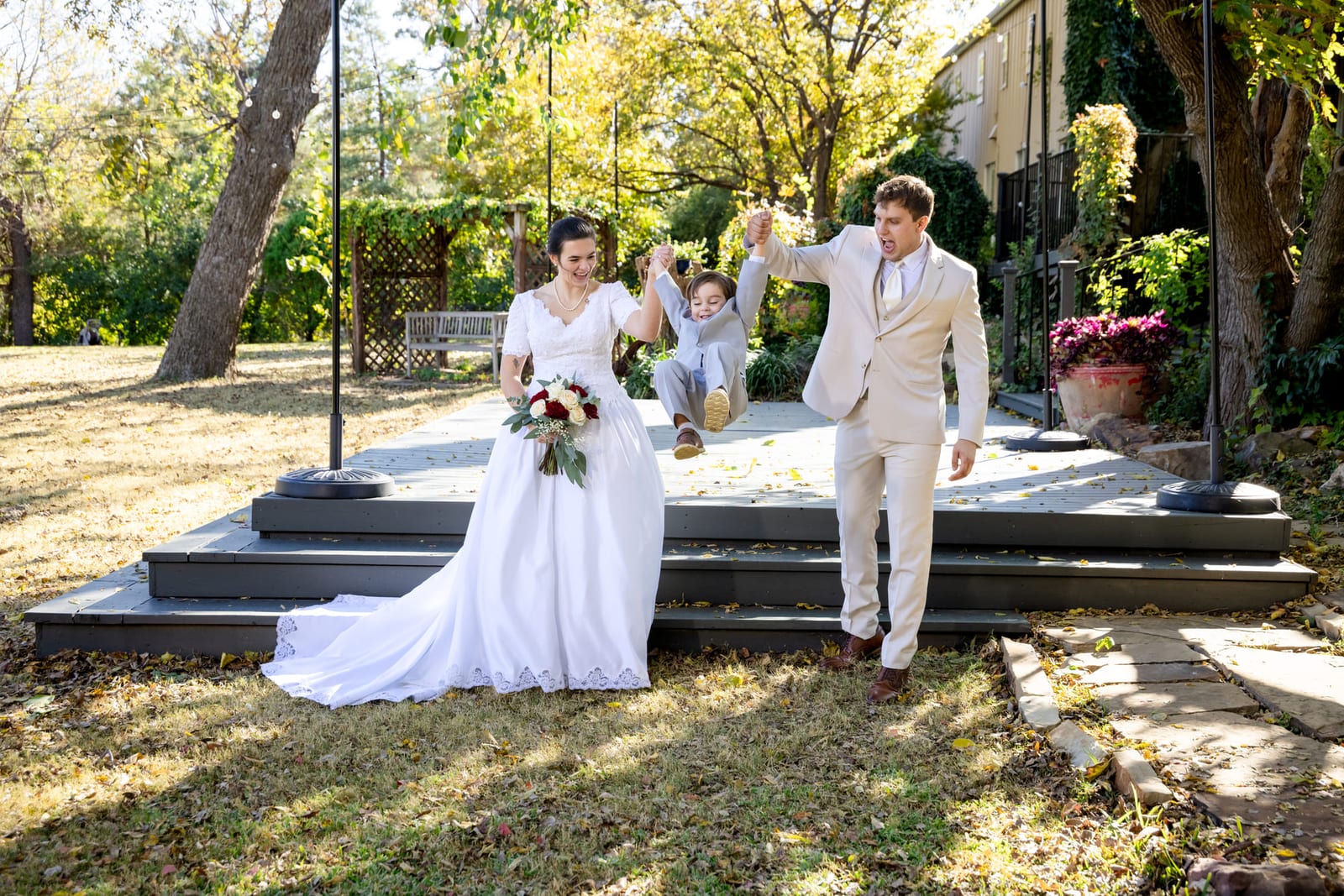 A bride and groom on the venue steps after the ceremony, her train spread down the stone.